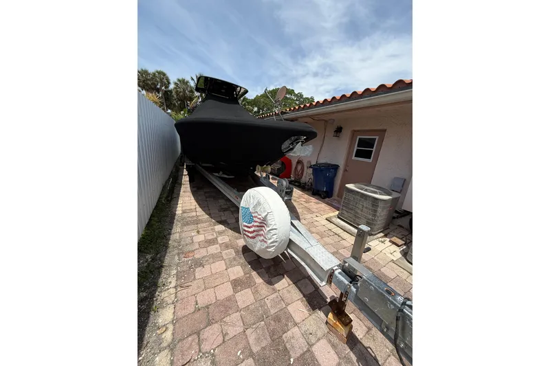 Slide: The Image of Covered 2015 Blackwood 27 boat on trailer in driveway, American flag tire cover. - 7