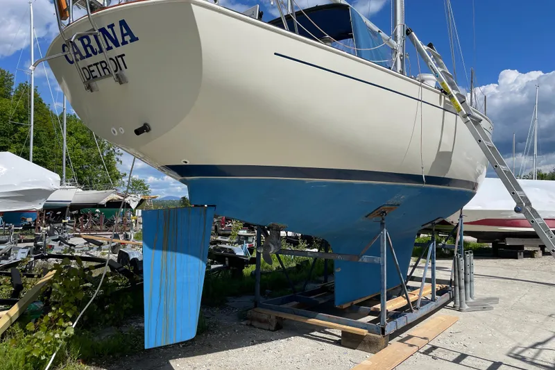 Slide: The Image of 1981 Hinterhoeller Niagara 35 sailboat on dry dock, blue hull, sunny day. - 15