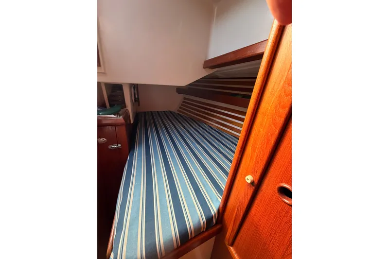 Slide: The Image of Interior cabin of 1981 Hinterhoeller Niagara 35 sailboat with striped bedding. - 3