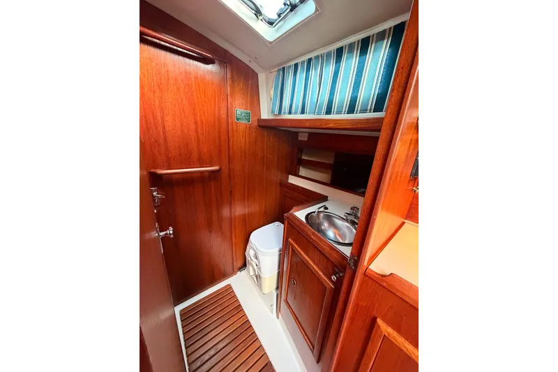 Slide: The Image of 1981 Hinterhoeller Niagara 35 yacht interior with wooden cabinetry and compact sink area. - 4