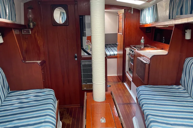 Slide: The Image of Interior of 1981 Hinterhoeller Niagara 35 sailboat with wood finish and striped upholstery. - 7