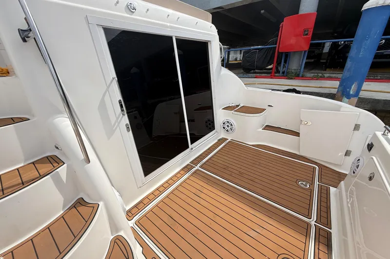 Slide: The Image of 2007 Meridian 459 Motoryacht deck with teak flooring and white accents. - 42