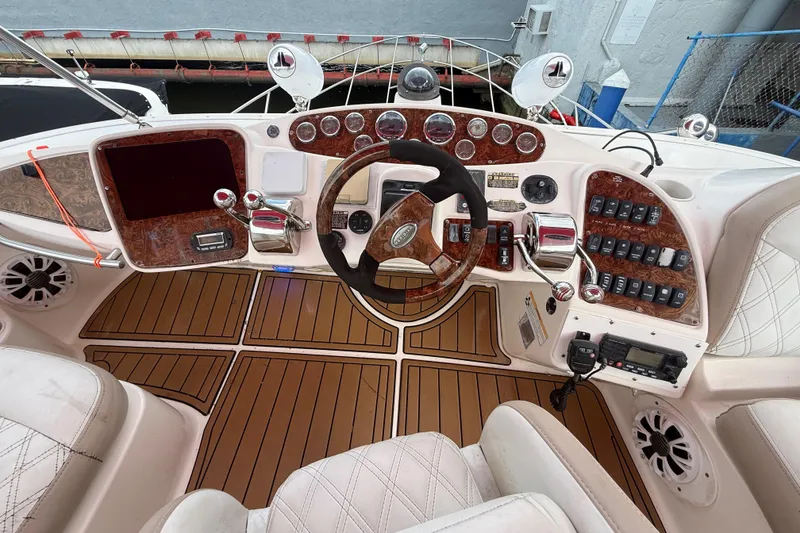 Slide: The Image of 2007 Meridian 459 Motoryacht helm with gauges and controls, docked at marina. - 6