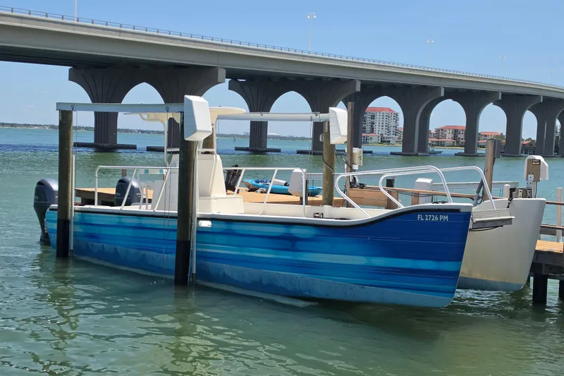 The Image of Custom Exuma Catamaran 32, 2014 model, on calm water under bridge. - 0