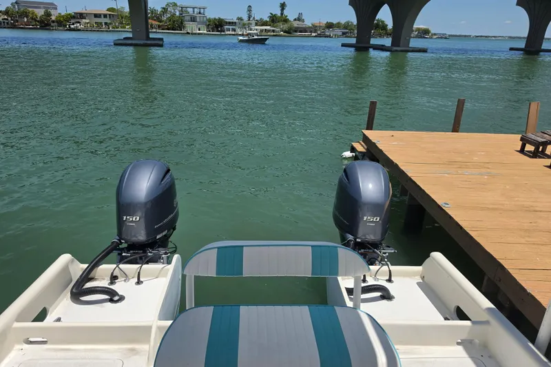 Slide: The Image of Outboard motor of 2014 Custom Exuma Catamaran 32 in green water. - 10