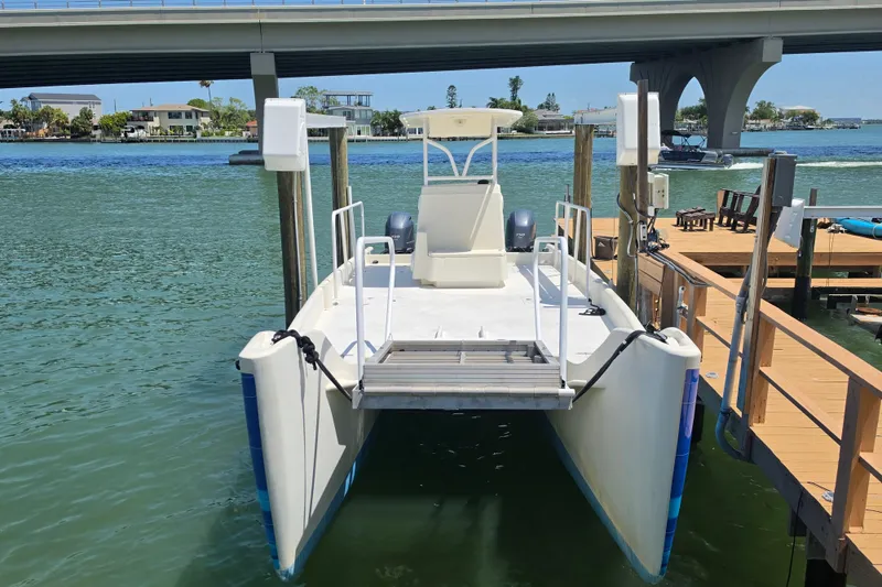 Slide: The Image of 2014 Custom Exuma Catamaran 32 docked under a bridge on a sunny day. - 23