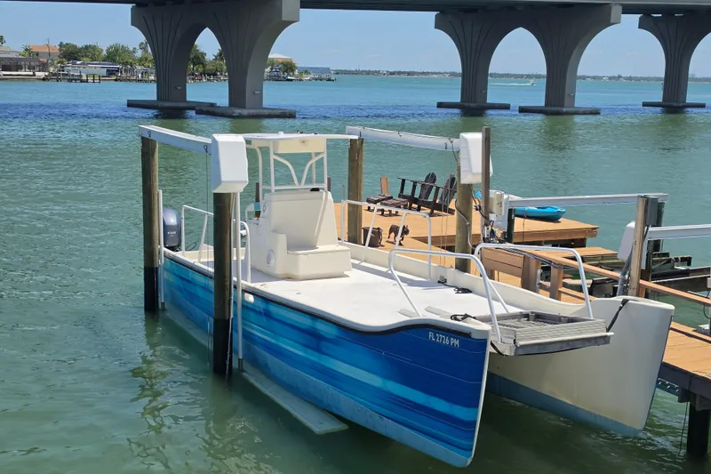 Slide: The Image of 2014 Custom Exuma Catamaran 32 docked near a bridge on calm waters. - 3