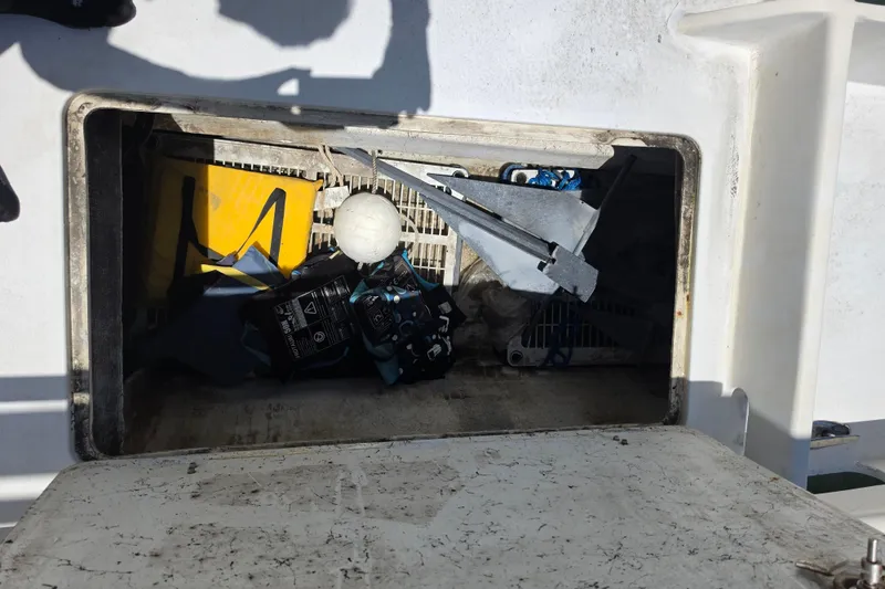 Slide: The Image of Custom Exuma Catamaran 32, 2014 model, docked near a bridge on a sunny day. - 44