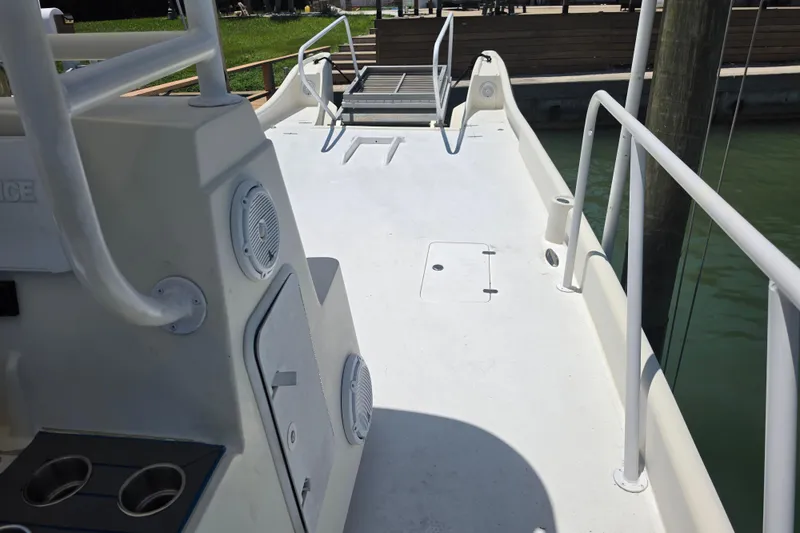 Slide: The Image of 2014 Custom Exuma Catamaran 32 deck with seating and outboard motor. - 58