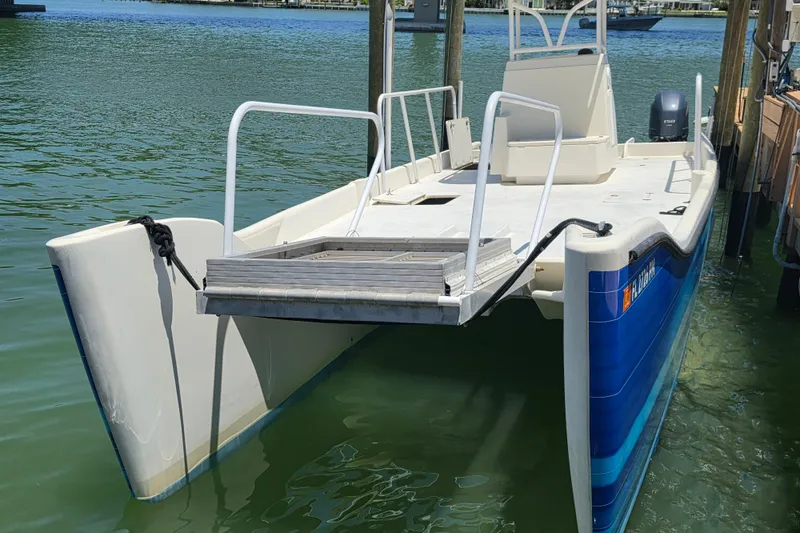 Slide: The Image of Deck view of a 2014 Custom Exuma Catamaran 32, featuring seating and storage hatch. - 68