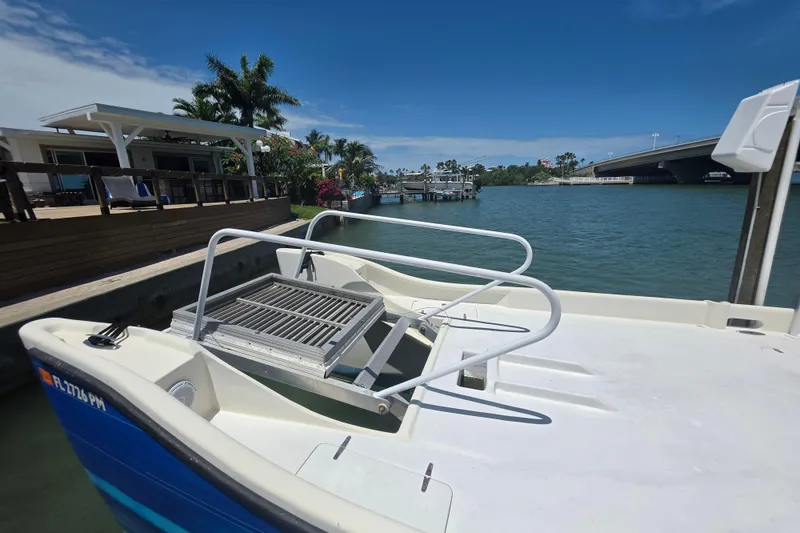 Slide: The Image of Outboard motor on 2014 Custom Exuma Catamaran 32 docked by wooden pier. - 72