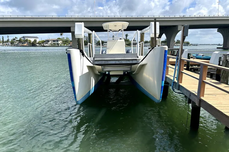 Slide: The Image of 2014 Custom Exuma Catamaran 32 docked near a bridge on clear water. - 78