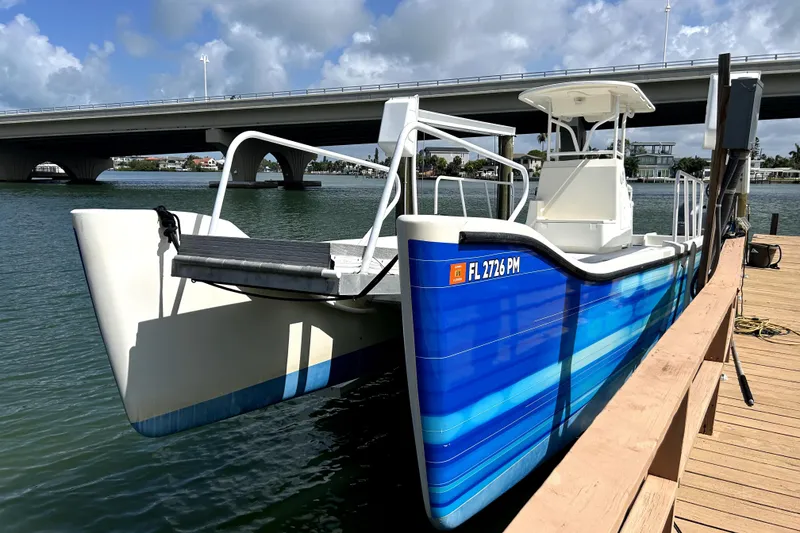 Slide: The Image of 2014 Custom Exuma Catamaran 32 docked near a bridge on a sunny day. - 79