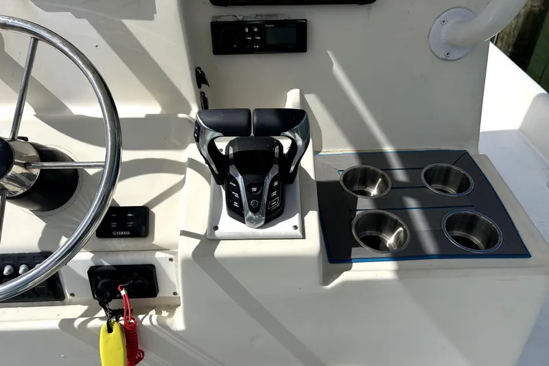 Slide: The Image of Cockpit controls of 2014 Custom Exuma Catamaran 32 with steering wheel and cup holders. - 88