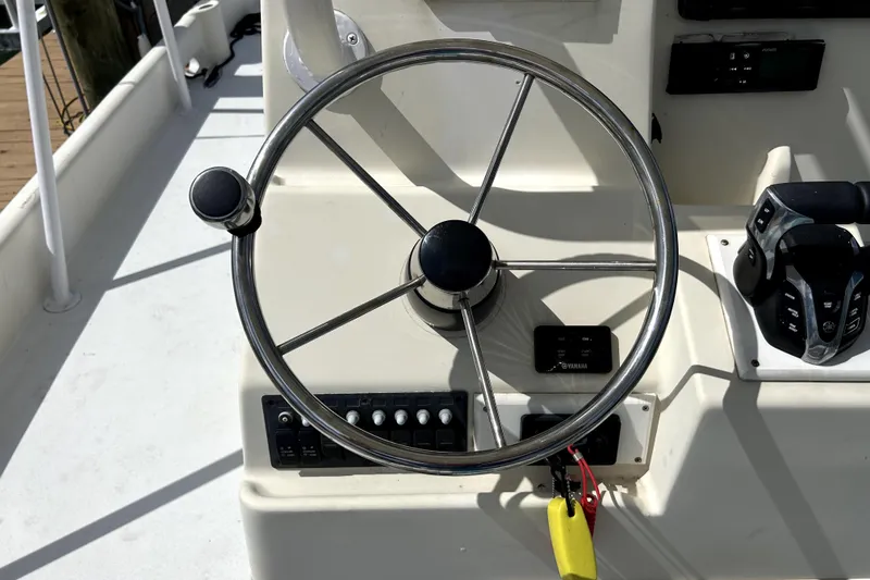 Slide: The Image of Steering wheel and controls of a 2014 Custom Exuma Catamaran 32. - 91