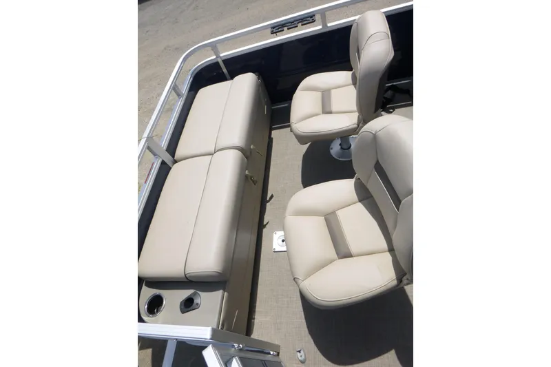Slide: The Image of 2025 Sun Tracker Fishin' Barge 22 DLX interior with beige seating and cup holders. - 13