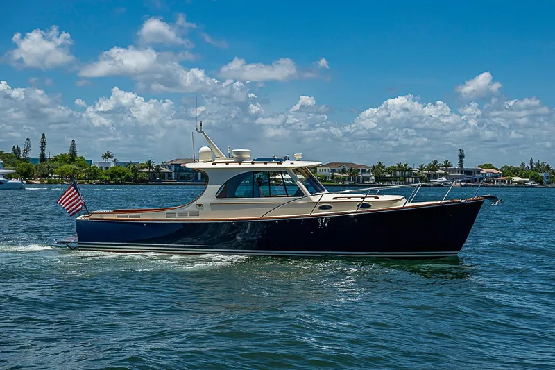 Slide: The Image of 2015 Hinckley Picnic Boat 37 MKIII cruising on a sunny day with American flag. - 1