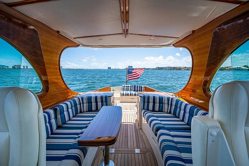 Slide: The Image of Luxurious 2015 Hinckley Picnic Boat 37 MKIII interior with striped seating and ocean view. - 10