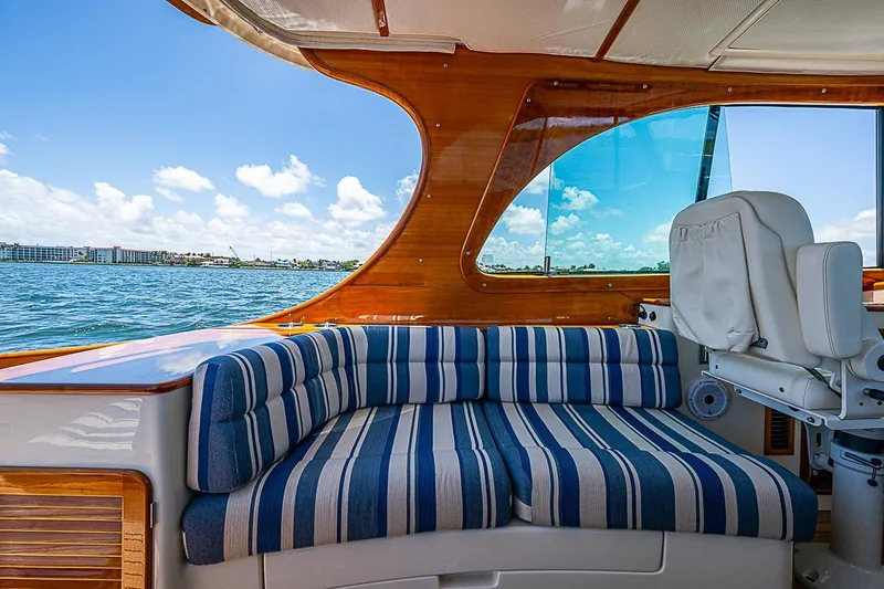Slide: The Image of Interior of 2015 Hinckley Picnic Boat 37 MKIII with striped seating and ocean view. - 11