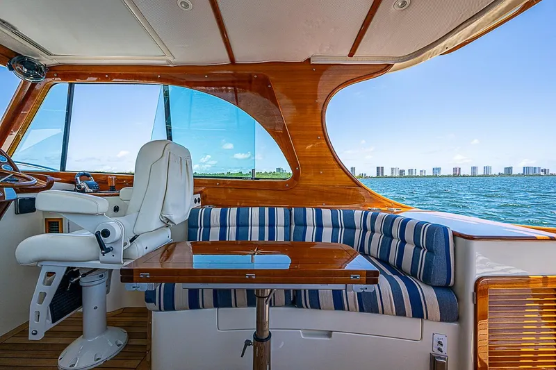 Slide: The Image of Interior of 2015 Hinckley Picnic Boat 37 MKIII with striped seating and ocean view. - 12