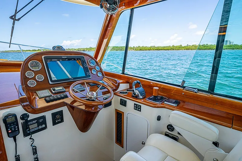 Slide: The Image of Helm of 2015 Hinckley Picnic Boat 37 MKIII with navigation system, steering wheel, and ocean view. - 14