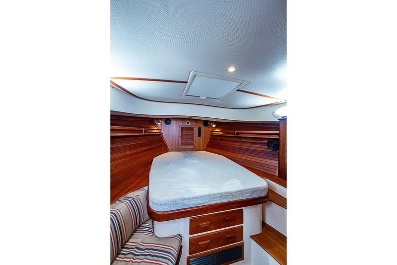 Slide: The Image of Interior cabin of 2015 Hinckley Picnic Boat 37 MKIII with wooden accents and cozy bed. - 19