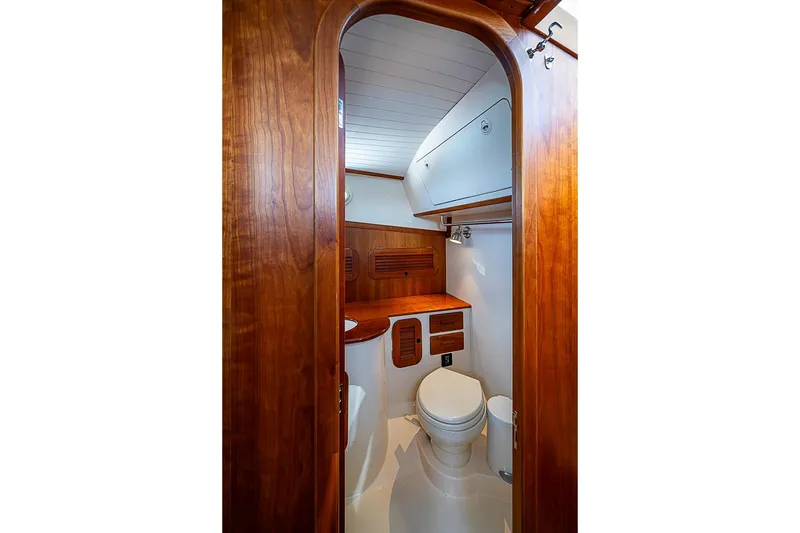 Slide: The Image of Hinckley Picnic Boat 37 MKIII 2015 interior bathroom with wooden cabinetry and modern fixtures. - 20