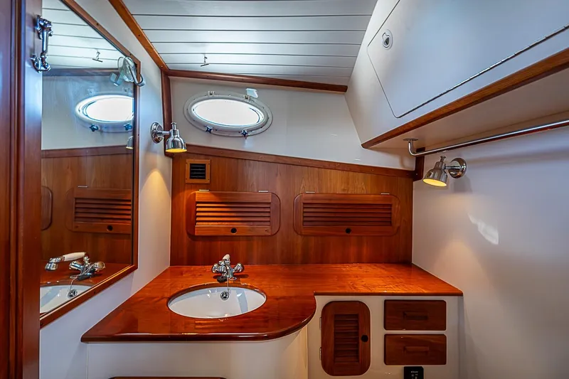 Slide: The Image of Luxurious wooden bathroom interior of 2015 Hinckley Picnic Boat 37 MKIII with sink and mirror. - 21