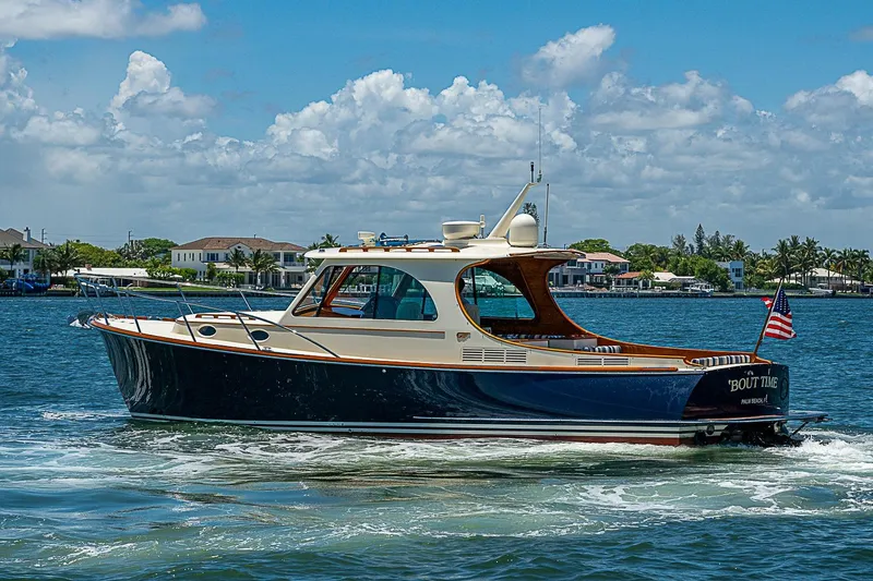 Slide: The Image of 2015 Hinckley Picnic Boat 37 MKIII cruising on a sunny day, American flag displayed. - 3