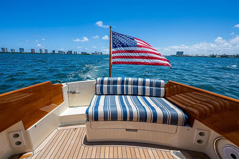 Slide: The Image of 2015 Hinckley Picnic Boat 37 MKIII with American flag, cruising on a sunny day. - 6