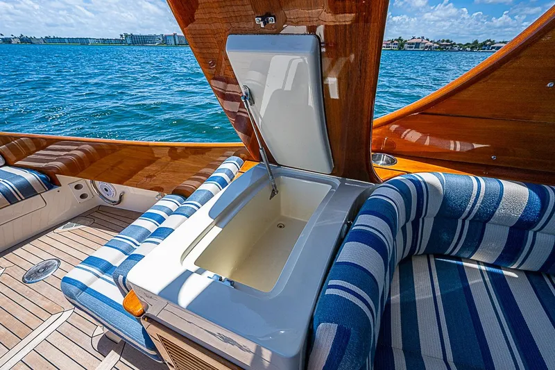 Slide: The Image of Luxurious 2015 Hinckley Picnic Boat 37 MKIII interior with striped seating and open storage compartment. - 9