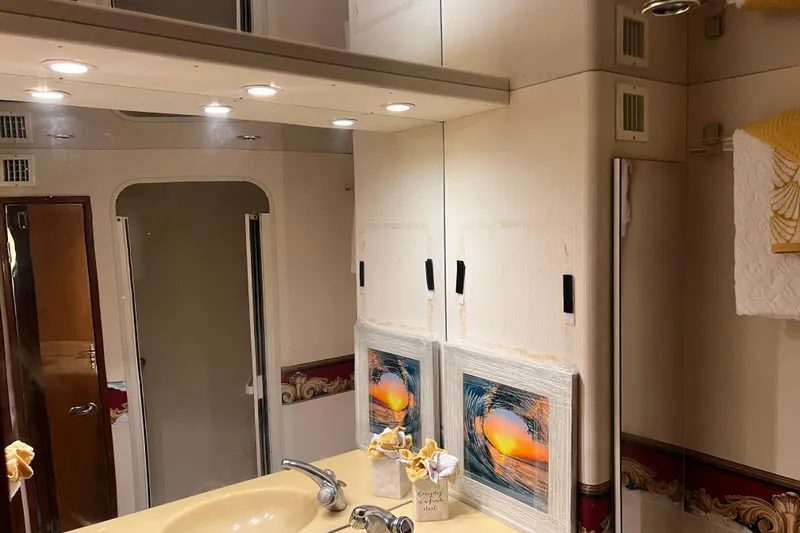 Slide: The Image of Bathroom interior of 1999 Viking 60 CPMY yacht with mirror, sink, and decorative elements. - 110