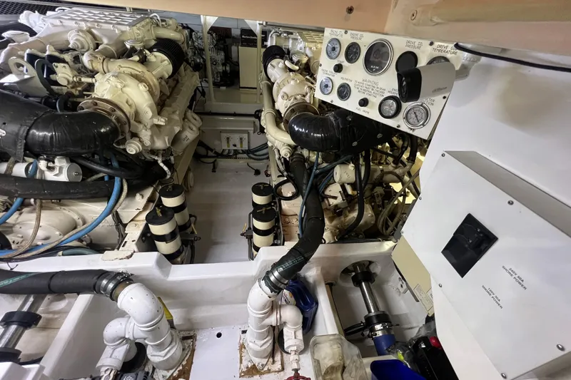 Slide: The Image of Engine room of a 1999 Viking 60 CPMY yacht, showcasing dual engines and control panel. - 113