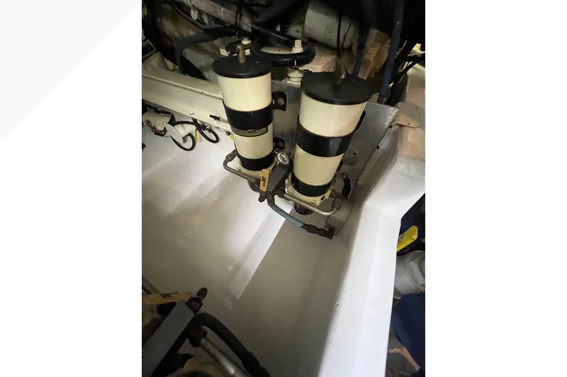 Slide: The Image of Engine compartment of 1999 Viking 60 CPMY with dual fuel filters. - 121