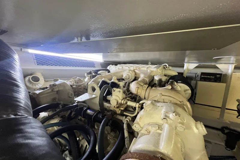 Slide: The Image of Engine room of a 1999 Viking 60 CPMY yacht, showcasing mechanical components. - 125