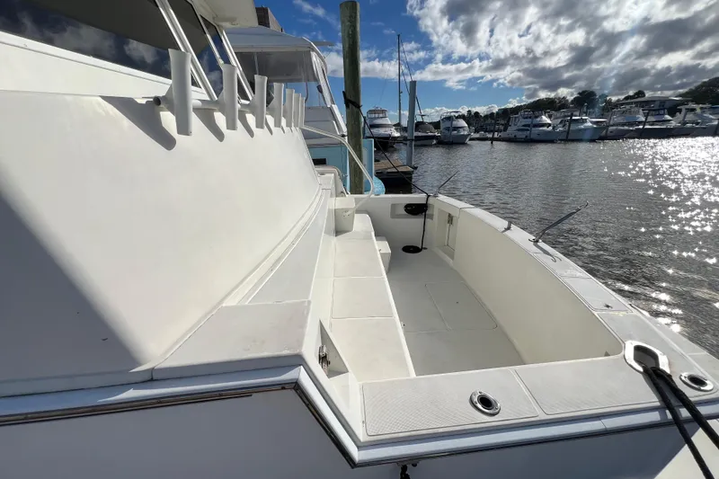 Slide: The Image of 1999 Viking 60 CPMY yacht docked at marina under a partly cloudy sky. - 13