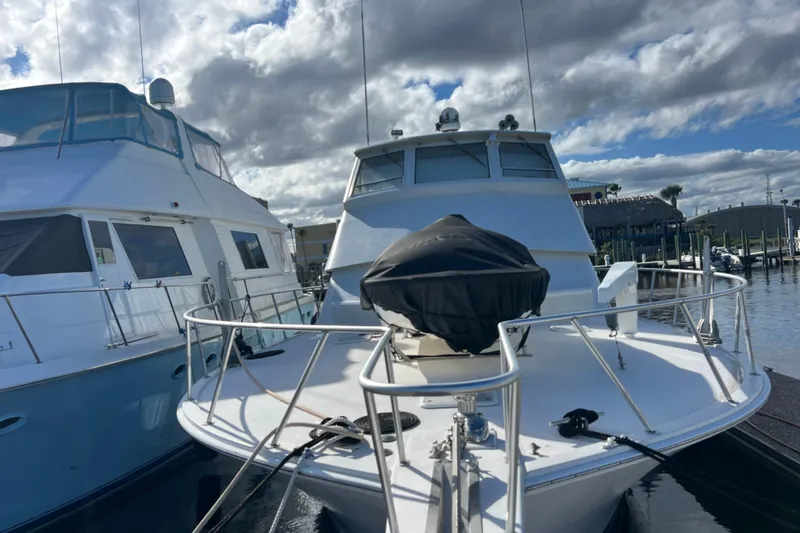 Slide: The Image of 1999 Viking 60 CPMY yacht docked under cloudy skies. - 2