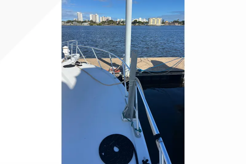 Slide: The Image of 1999 Viking 60 CPMY yacht docked by waterfront with city skyline in background. - 26