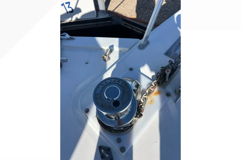 Slide: The Image of Anchor windlass on 1999 Viking 60 CPMY yacht deck, featuring Maxwell branding. - 27