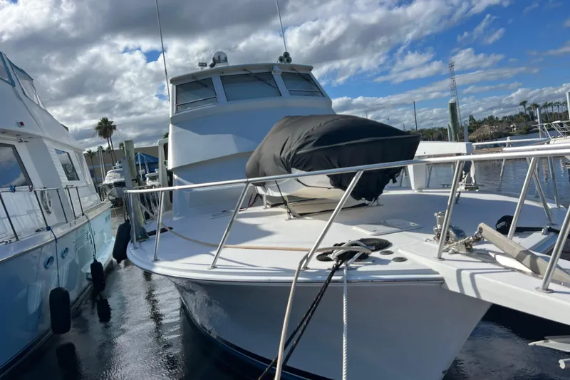 Slide: The Image of 1999 Viking 60 CPMY yacht docked at marina under cloudy sky. - 3