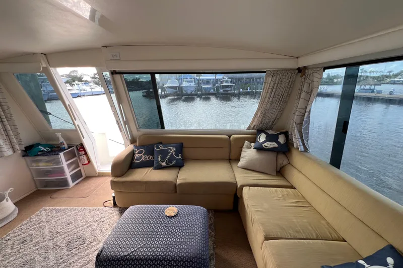 Slide: The Image of Interior of 1999 Viking 60 CPMY yacht with cozy seating and waterfront view. - 31