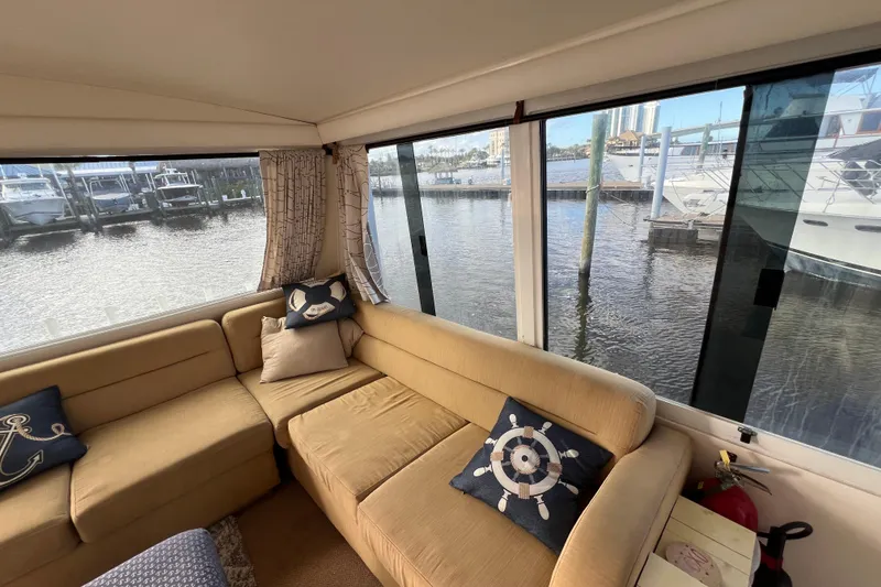 Slide: The Image of Cozy interior of 1999 Viking 60 CPMY yacht with waterfront view. - 35