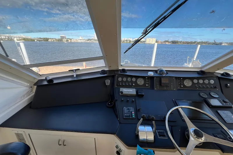 Slide: The Image of Cockpit view of 1999 Viking 60 CPMY yacht with steering wheel and control panel. - 41