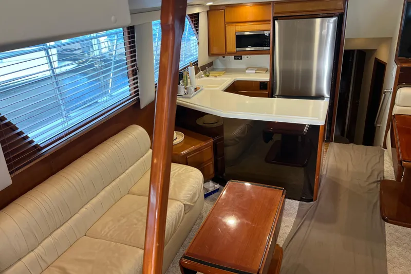 Slide: The Image of Interior of 1999 Viking 60 CPMY yacht with modern kitchen and cozy seating area. - 59