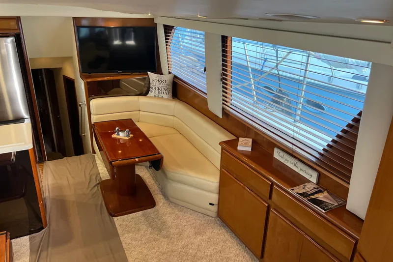 Slide: The Image of Luxurious interior of 1999 Viking 60 CPMY yacht with cozy seating and elegant wood finishes. - 60