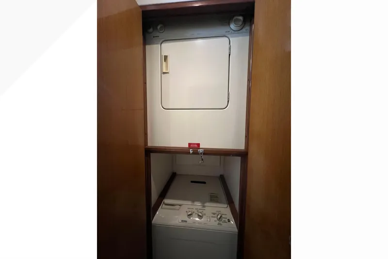 Slide: The Image of Laundry area inside 1999 Viking 60 CPMY yacht with washer and dryer. - 77