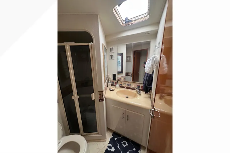 Slide: The Image of Bathroom interior of 1999 Viking 60 CPMY yacht with shower and skylight. - 82