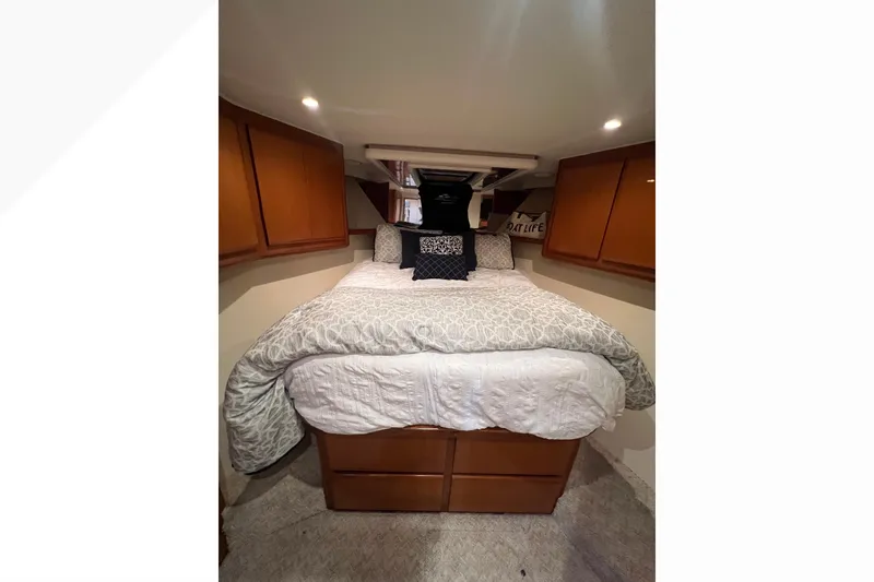 Slide: The Image of Cozy bedroom in 1999 Viking 60 CPMY yacht with wooden cabinets and soft bedding. - 83