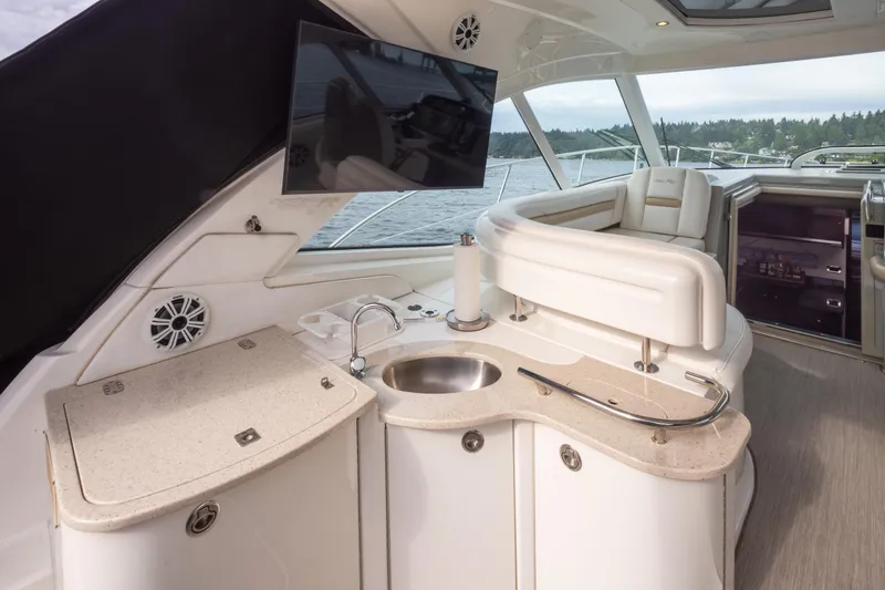 Slide: The Image of Luxurious interior of 2010 Sea Ray 500 Sundancer yacht with kitchenette and seating area. - 11