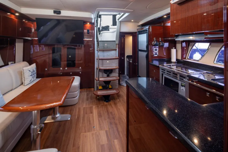 Slide: The Image of Luxurious interior of 2010 Sea Ray 500 Sundancer yacht with modern kitchen and seating area. - 16